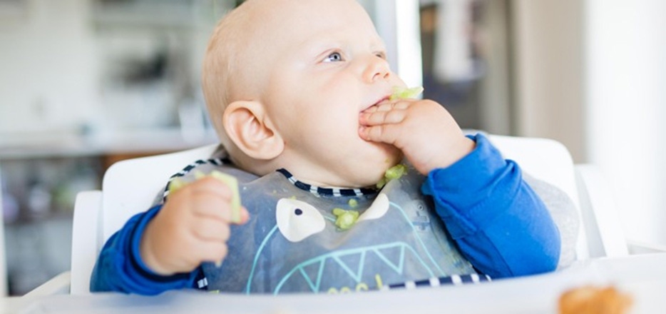 Baby eating greens